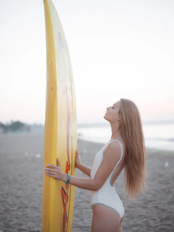 Girl Looking at a Surfboard Girl Looking at a Surfboard